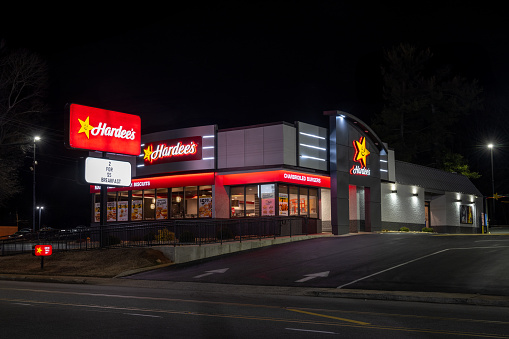 Canton, North Carolina, United States - 5 January 2024:  Hardee's at anight.  Lit marquee and light posts.