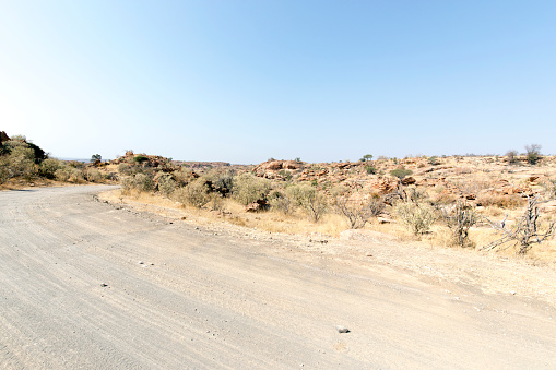 Long Country Desert Road through the Desert and Prairie Scenic Landscape of Namib-Naukluft National Park near Sossusvlei. Sesriem, Namib-Naukluft Park, Namibia, South West Africa.