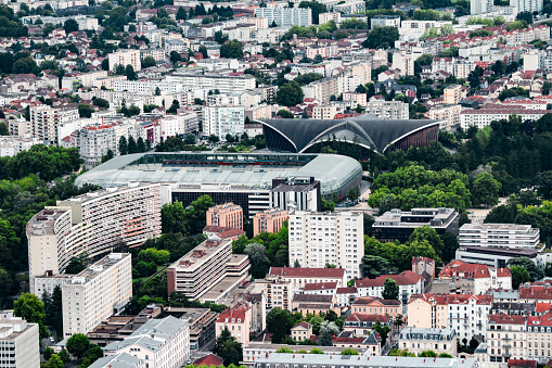 High angle view of sport venues in Grenoble, like stadium and sports hall. This image was taken in Grenoble city on a cloudy summer day, in the department of Isere, Auvergne-Rhône-Alpes region in France, Europe.