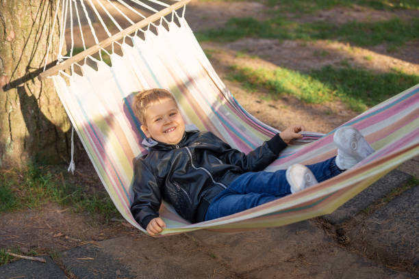 istock Cheerful little boy lying on hammock in a pine forest a heartwarming scene that resonates with precious childhood memories 1915065720