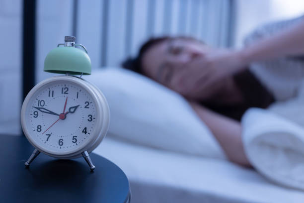 istock Asian woman suffer from insomnia on her bed at night 1915082044