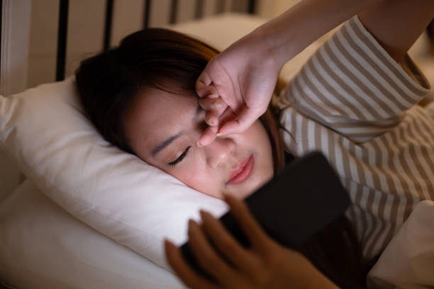 istock Insomnia asian woman using mobile phone on her bed at night 1915082049
