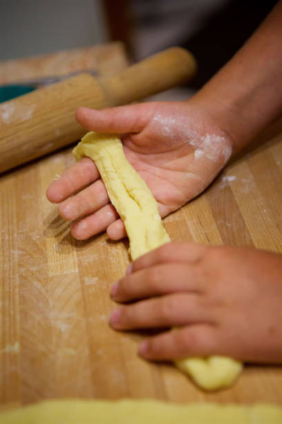 istock Children's hands knead the dough for the cake. 1915083621