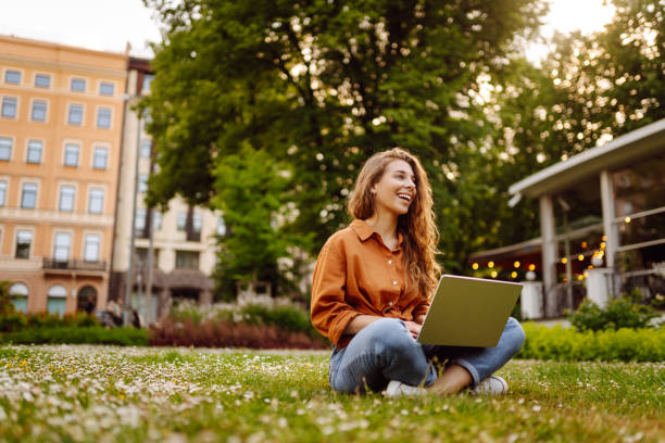 istock Cute woman spending time outdoors with laptop. 1915112144