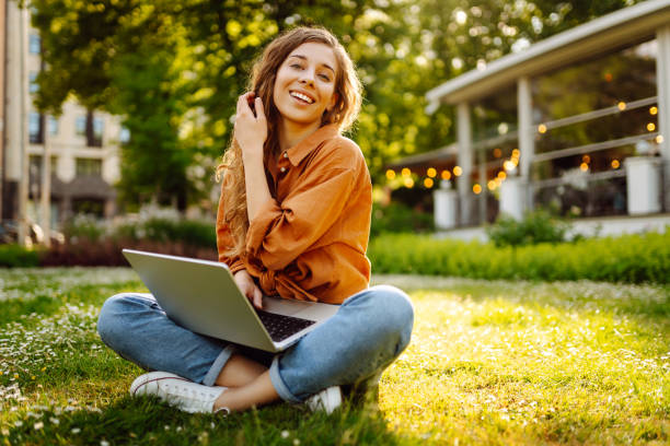 istock Cute woman spending time outdoors with laptop. 1915112145