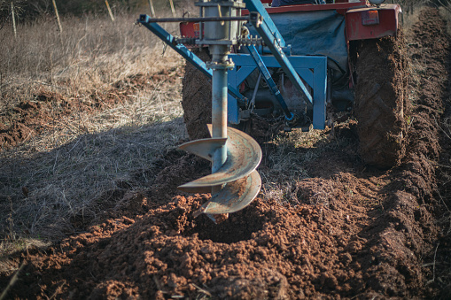 Auger for digging holes in the ground