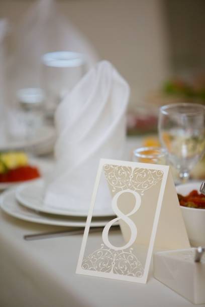 table number for a big celebration or celebration. seating of guests of a large event according to the list. details of the decor. - clipping path wedding invitation invitation message stock-fotos und bilder