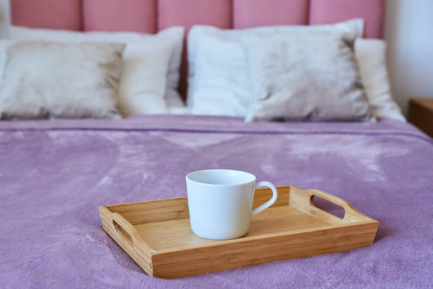 istock A cup of tea on a tray is on the bed. Breakfast in bed. 1915127719