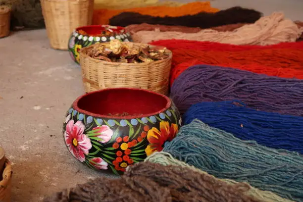 Photo of Natural ingredients needed to dye the threads for a traditional mexican carpet, displayed at a traditional workshop, Oaxaca, Mexico