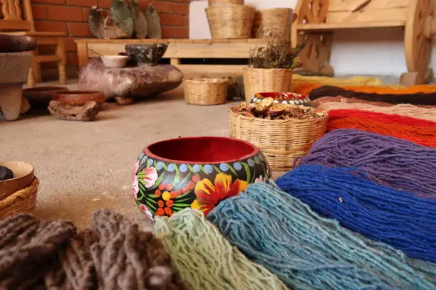 Photo of Display of natural ingredients that are needed to dye the threads for a traditional mexican carpet, Oaxaca, Mexico