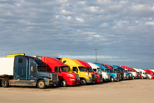 Group of semi trucks parked at truck stop, American transport concept, Missouri, United States.