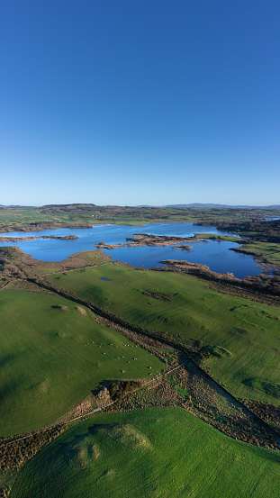 Aerial view of farmland in rural Scotland on bright winter afternoon