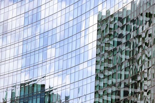 Modern architecture close up with mirror window reflections of building in Bangkok, Backgrounds