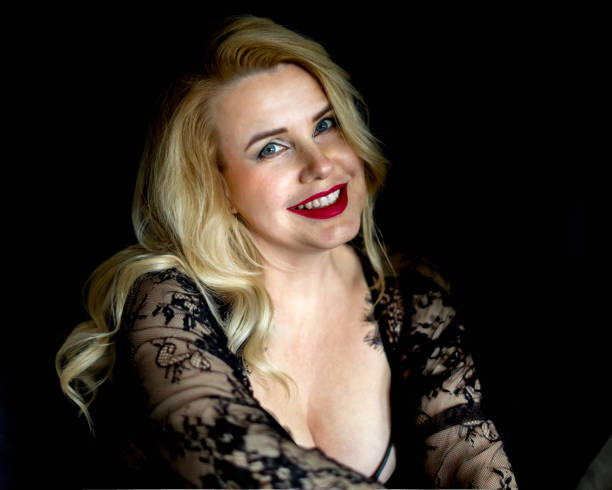 istock blonde in a lace black dress 1915297514