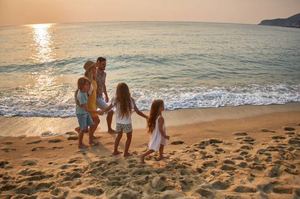 istock A family walks hand in hand down a tropical paradise beach during sunset 1915313414