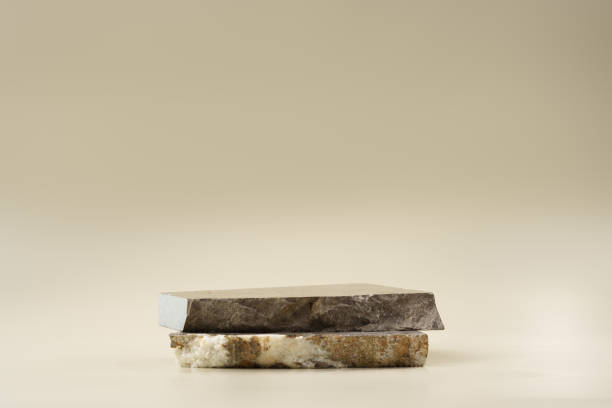 istock Pieces of granite stone on beige background for display 1915315504
