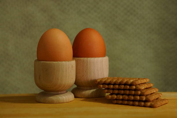 Beautiful background with eggs, two eggs in wooden bowls