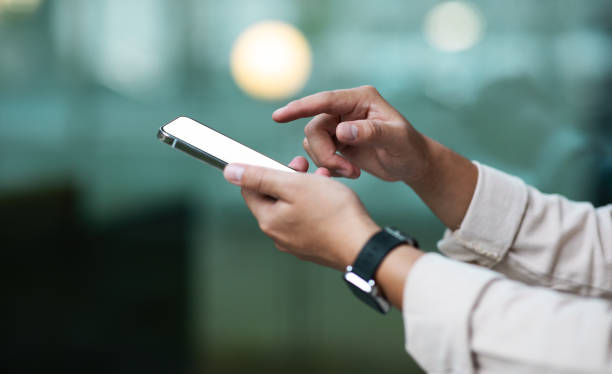 istock Unrecognizable businessman holding modern smartphone with white blank screen 1915346353