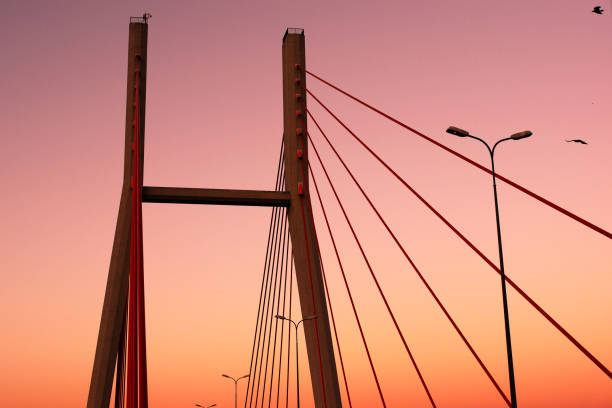 istock Bridge construction against beautiful orange sky during sunset 1915351718