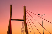 Bridge construction against beautiful orange sky during sunset