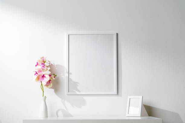 istock White wooden frame on white wall above the table 1915357984