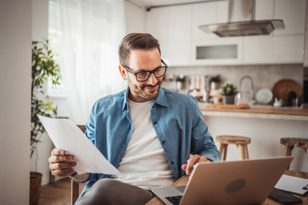 istock Photo of a young man working at home using modern technologies 1915377787