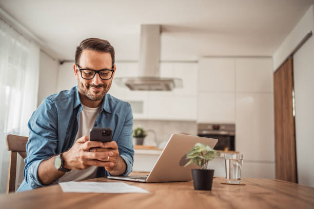 istock Photo of a young man working at home using modern technologies 1915379048