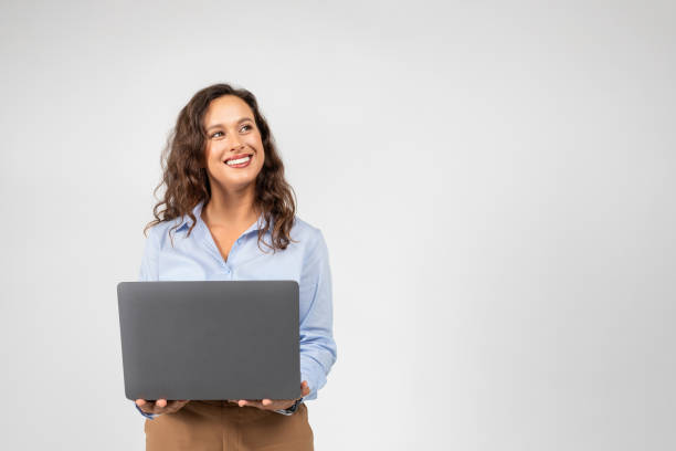 istock Positive caucasian millennial businesswoman typing on computer, chatting, look at empty space 1915381545
