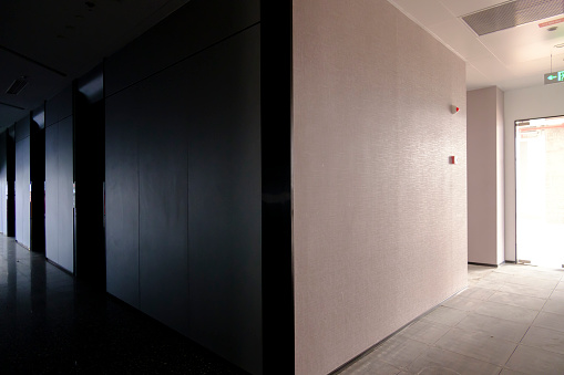 Image of modern corridor with elevator with glass doors in office building