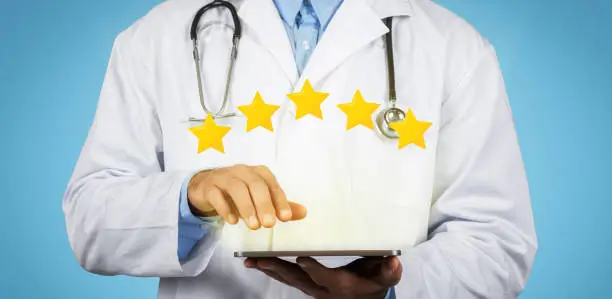 Photo of Doctor with tablet, surrounded by glowing 5-star rating