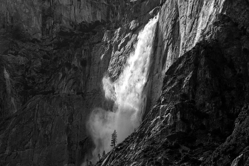 Lighting cascade through a Yosemite Waterfall dancing in the winde and granite