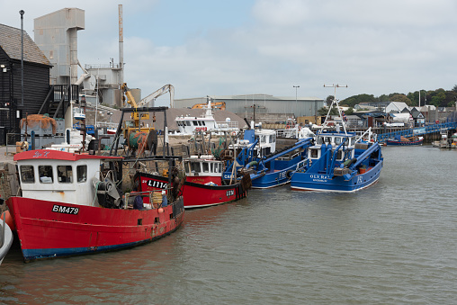 Whitstable, United Kingdom, June 8 2023: Fishing boats moored at Whitstable harbor in Kent England