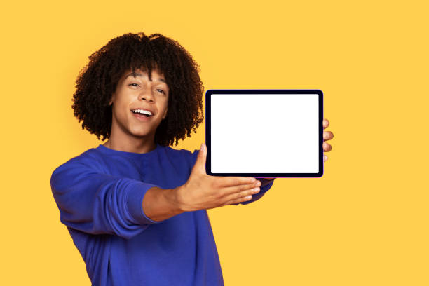 istock Online Offer. Handsome Black Man Showing Digital Tablet With White Screen 1915482016