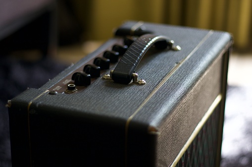 antique guitar amplifier, suitcase type, black and white photograph, musicians, bands, instruments