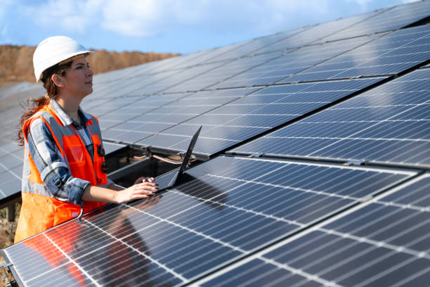 istock young engineer inspect installation of solar panels installed check  with blueprint on the field, with recording inspection data on pc. 1915593790