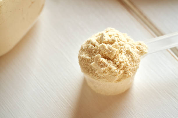 istock Whey protein powder in a plastic measuring cup 1915600170