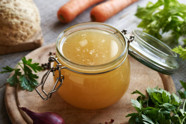 istock A jar of chicken bone broth or soup with fresh vegetables 1915602328