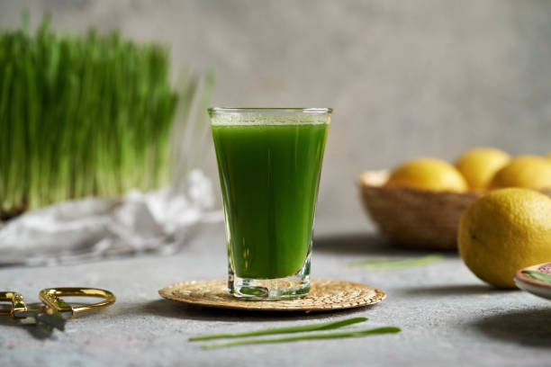 istock Fresh green barley grass juice in a glass cup 1915603917