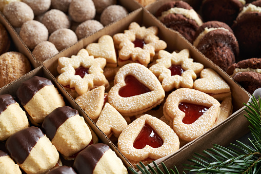 Linzer and other homemade Christmas cookies in a gift box made of recycled paper