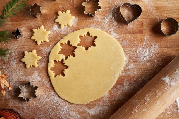 istock Raw pastry dough from which star shapes are being cut out 1915623363