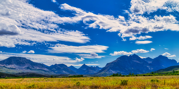 Green grassy prairie and sky with cumulus in Utah, along highway 89 near Le Fevre Overlook, with Grand Staircase Escalante in the distance.