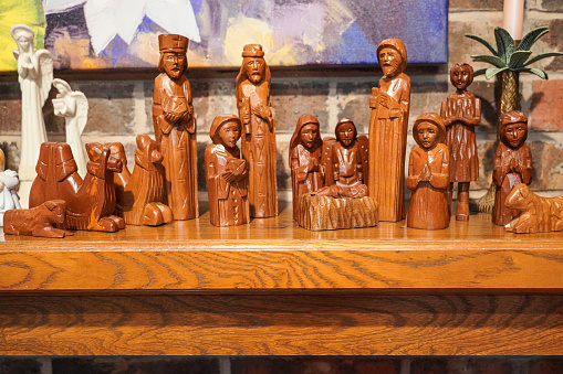 Three Wise Men and shepherds visit baby Jesus, his mother Mary and father Joseph in a hand-carved teakwood nativity set from the Philippines.
