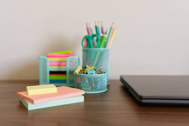 Detail of an office table with various study supplies next to a notebook - Make Study Great.