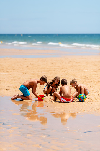 Children playing in the sand at the beach