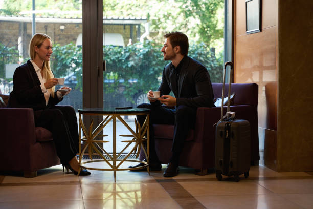 istock Young happy couple drinking coffee in lobby bar 1915660718