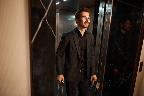 istock Cropped photo of cheerful man walking out elevator 1915661297