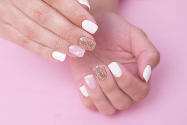 istock Female hands with romantic manicure nails, white gel polish 1915674669