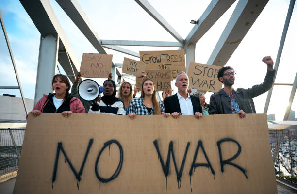 istock Multiracial diverse ages people protesting against war and violence in the world. Group of activists 1915698663
