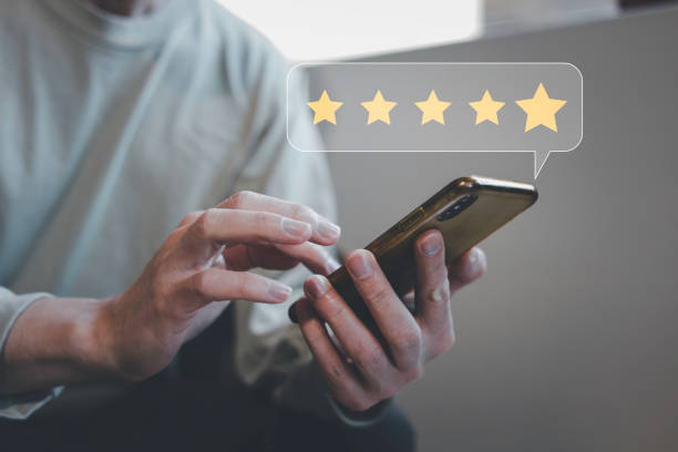 istock customer service evaluation and feedback rating. costumer review concept, man using phone chooses happy smiling face 1915712468