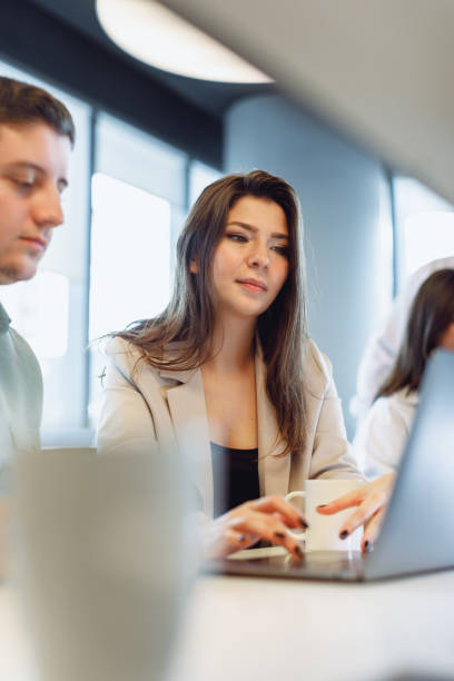 istock Efficient Businesswoman Manager Analyzing Data with Colleagues in Modern Office 1915719705